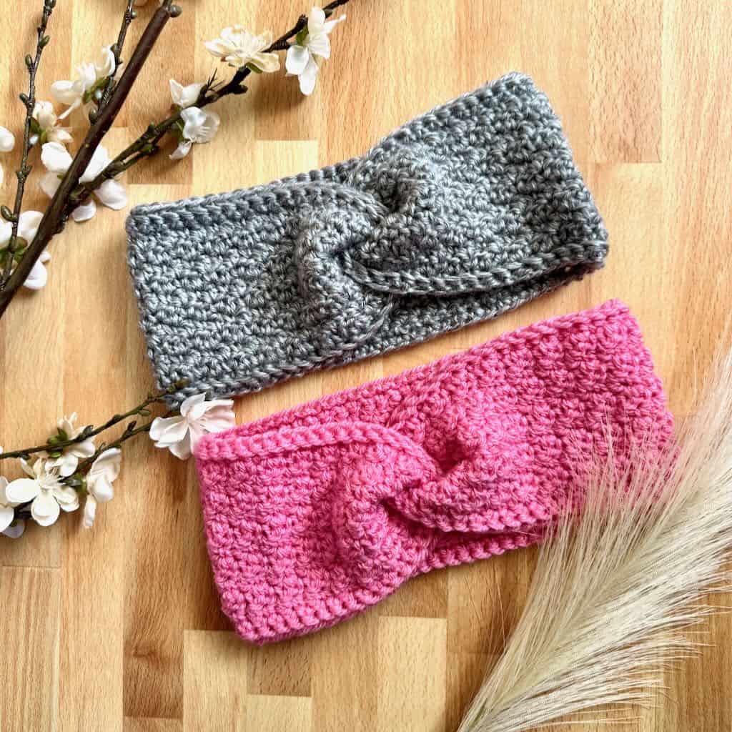 A photo of the Twisted Sister Ear Warmer with flowers