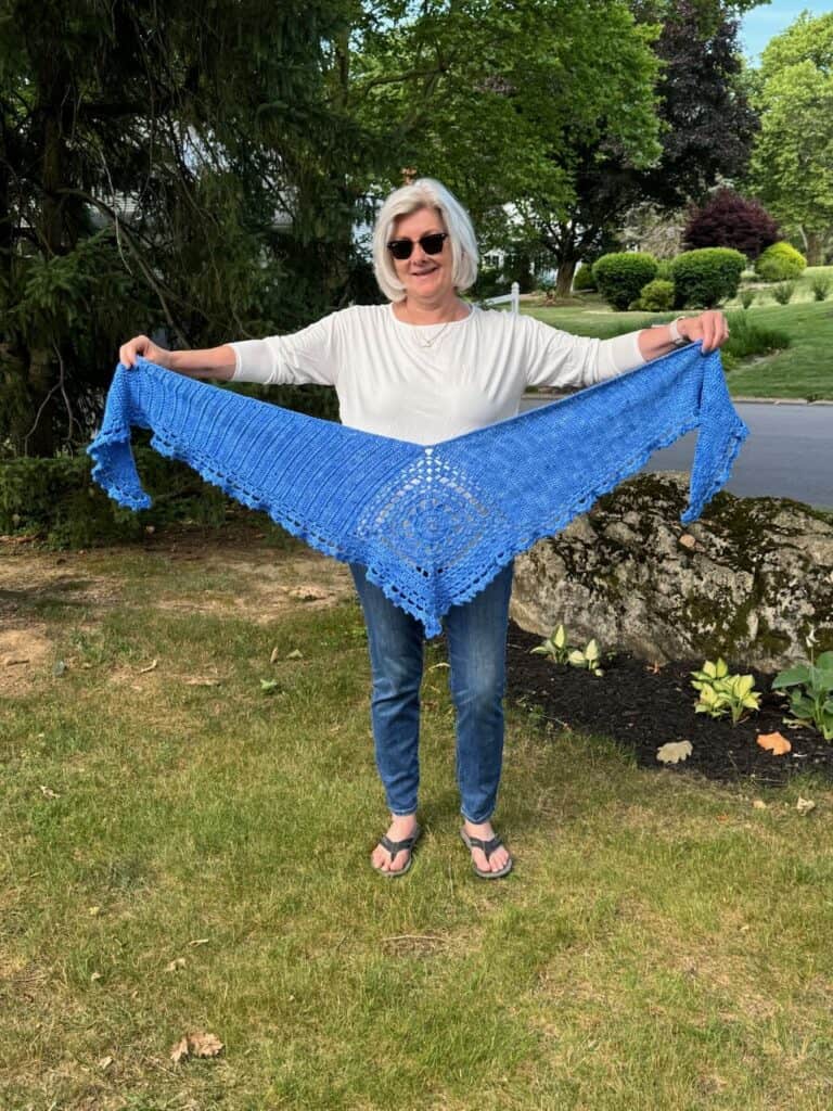 A photo of the Cenise crochet shawl held out