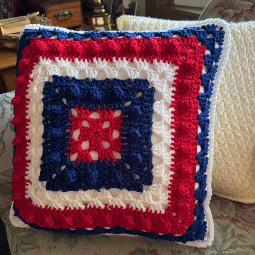 A photo of the front granny square panel of the I Love Baseball Pillow