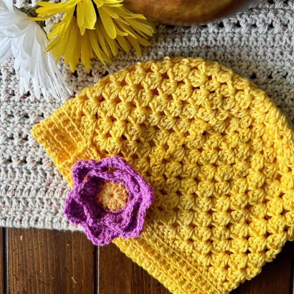 A photo of a yellow granny stitch hat