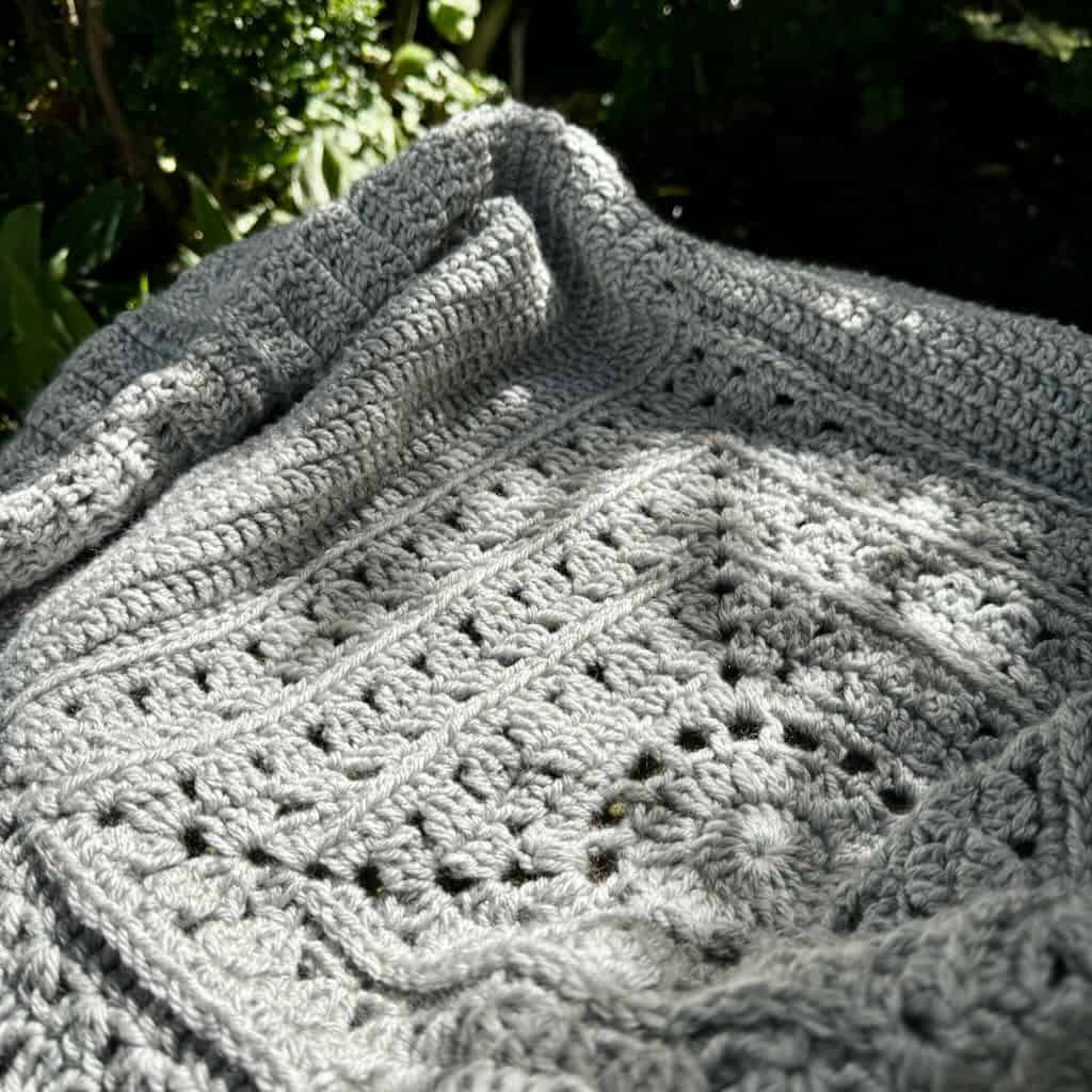 Photo of the center square of the cocoon cardigan on a bench in the sun